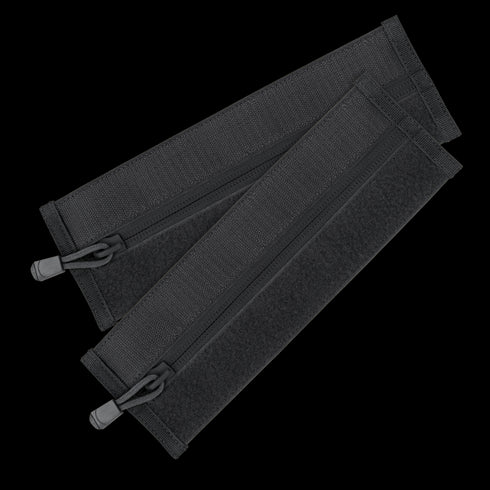 The Condor VAS Zipper Strips are two black fabric straps with zippers and hook-and-loop fasteners, arranged in a crisscross pattern—perfect for organizing bushcraft or first responder gear.