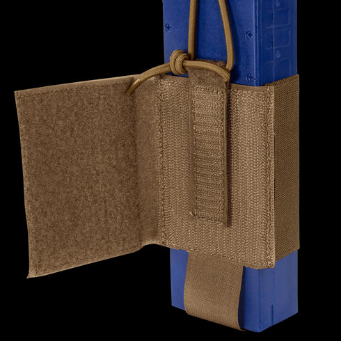 A close-up of the Condor VAS Wing Pouch in tan, designed for EDC or bushcraft, securely holds a blue rectangular object with adjustable straps and a hook-and-loop flap.