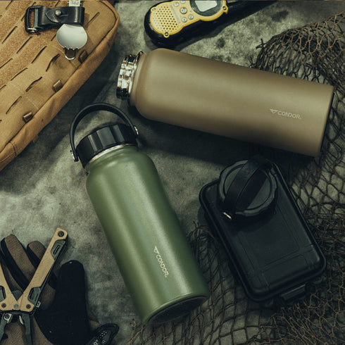Two Condor Vacuum Sealed Thermal Bottles—one green, one brown—rest beside a tactical pouch, gloves, black case, fishing net, multitool, and yellow walkie-talkie: a perfect EDC lineup for bushcraft enthusiasts.
