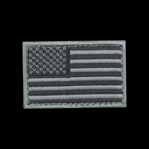The Condor US Flag Patch features a grayscale American flag with stars in the upper left and horizontal stripes, ideal for law enforcement or shooting range enthusiasts.