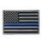 The Condor US Flag Patch features a black and white American flag with a single blue stripe across the center, honoring First Responder service and dedication.
