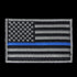 The Condor US Flag Patch features a black and white American flag with a single blue stripe across the center, honoring First Responder service and dedication.