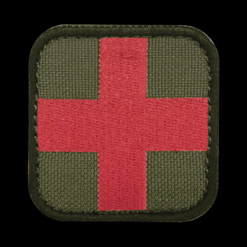 The Condor Medic Patch is a fabric military patch with a red cross on an olive green background and rounded black edges—ideal for bushcraft or use at the shooting range.