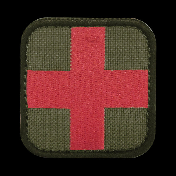 The Condor Medic Patch is a fabric military patch with a red cross on an olive green background and rounded black edges—ideal for bushcraft or use at the shooting range.