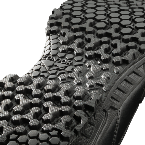 Close-up view of the black Brigade 8" Tactical Boots - Zip by Condor, showing a textured sole with a hexagonal tread pattern and "CONDOR" embossed in the center.