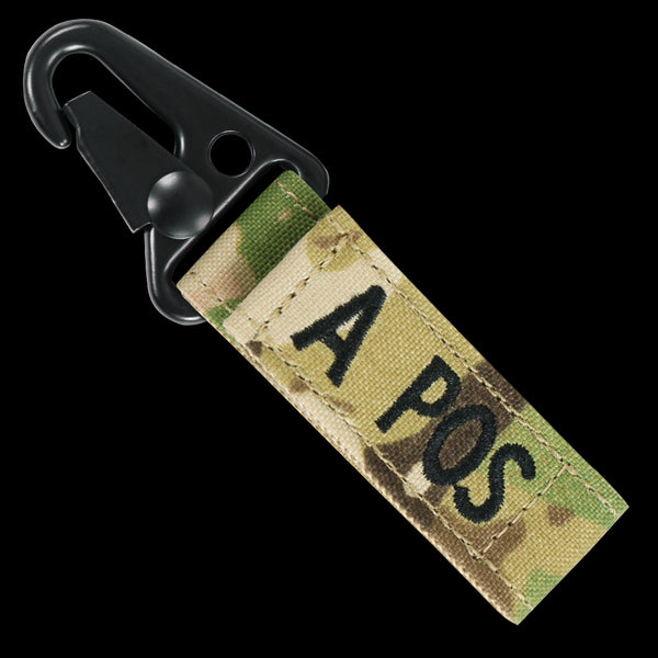 The Condor Blood Type Key Chain Scorpion OCP is a camouflage fabric keychain with a black metal clip, labeled A POS in black, perfect for bushcraft enthusiasts or first responders needing quick blood type info.