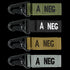 Condor Blood Type Key Chain: four metal-clip, fabric-strap keychains labeled A NEG in green, black, tan, and gray.