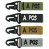 The Condor Blood Type Key Chain set includes four keychains with black metal clips and fabric straps in green, black, brown, and gray, each featuring “A POS” embroidered text.