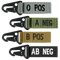 The Condor Blood Type Key Chain set features four fabric keychains with plastic clips, each labeled O POS, A NEG, B POS, or AB NEG on different colored straps.