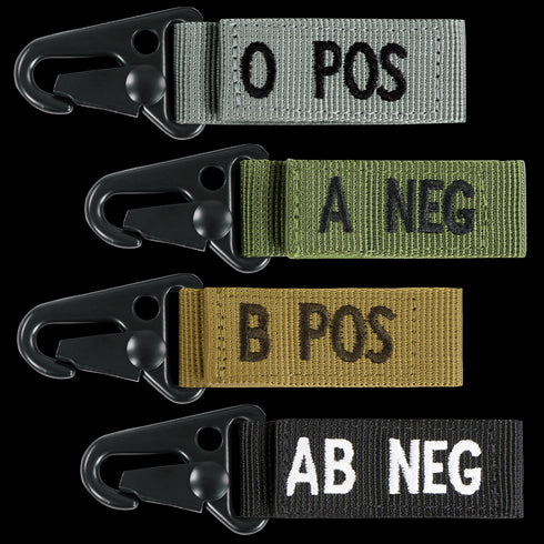 The Condor Blood Type Key Chain set features four fabric keychains with plastic clips, each in a unique color and labeled O POS, A NEG, B POS, or AB NEG.
