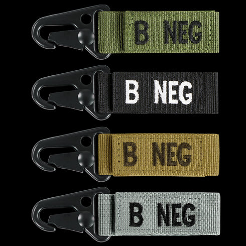 The Condor Blood Type Key Chain set includes four keychains with plastic clips and fabric straps in green, black, tan, and gray, each boldly labeled with B NEG to display your blood type.