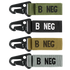 The Condor Blood Type Key Chain set includes four keychains with plastic clips and fabric straps in green, black, tan, and gray, each boldly labeled with B NEG to display your blood type.