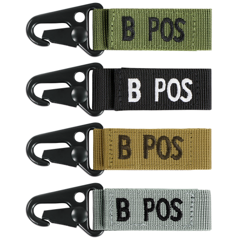 The Condor Blood Type Key Chain set features four keychains with plastic clips and fabric tags labeled B POS, available in green, black, tan, and gray.