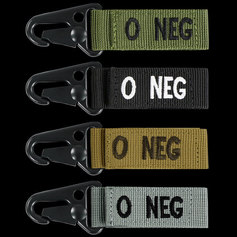 The Condor Blood Type Key Chain set includes four fabric keychains with metal clips, each labeled O NEG in green, black, tan, and gray to indicate O negative blood type.