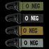 The Condor Blood Type Key Chain set includes four fabric keychains with metal clips, each labeled O NEG in green, black, tan, and gray to indicate O negative blood type.