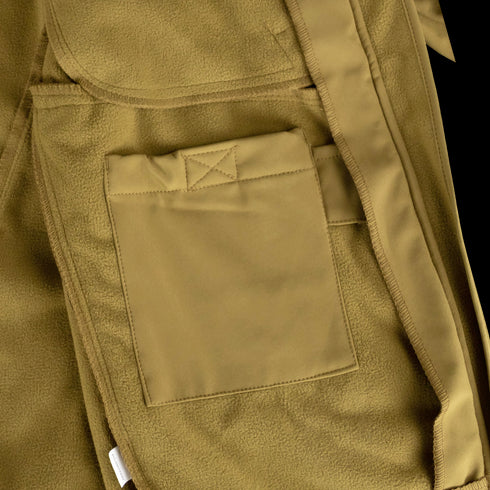 Close-up of the Condor Phantom Softshell Jacket in tan, showing a rectangular fabric pocket with visible stitching and a belt loop on the right side.