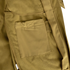 Close-up of the Condor Phantom Softshell Jacket in tan, showing a rectangular fabric pocket with visible stitching and a belt loop on the right side.