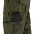 A black rifle magazine is partially inserted into a side pocket of the Condor Sentinel Tactical Pants in green.