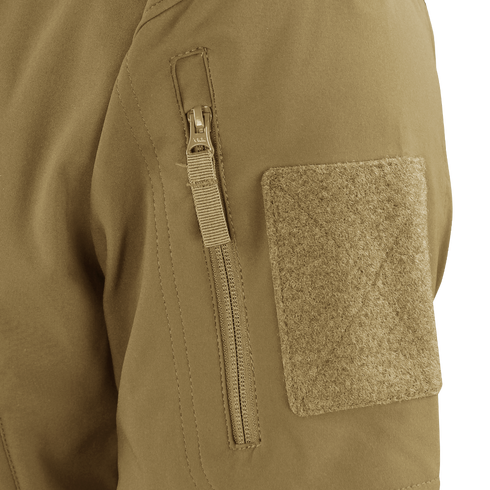 Close-up of the Condor Summit Zero Softshell Jacket’s tan sleeve, highlighting a vertical zipper pocket and a rectangular hook-and-loop patch.