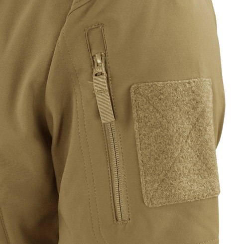 Close-up of the Condor Summit Zero Softshell Jacket’s tan sleeve, highlighting a vertical zipper pocket and a rectangular hook-and-loop patch.