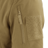 Close-up of the Condor Summit Zero Softshell Jacket’s tan sleeve, highlighting a vertical zipper pocket and a rectangular hook-and-loop patch.