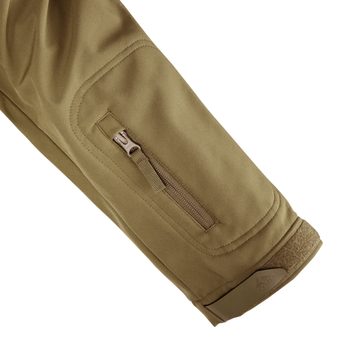 A close-up of the Condor Summit Zero Softshell Jacket in khaki shows its sleeve with a zippered pocket and hook-and-loop fastener at the cuff.