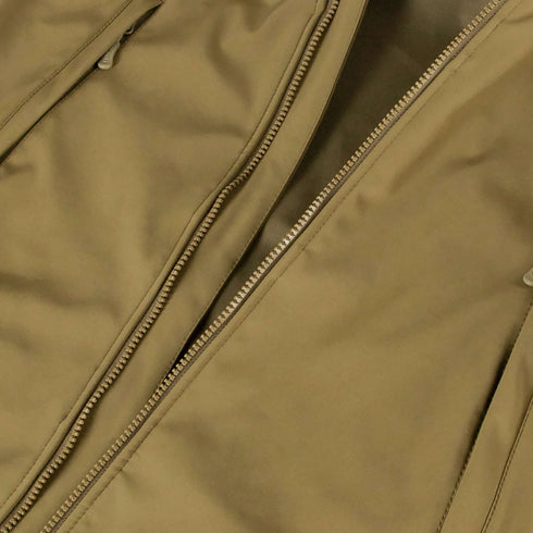Close-up of the Condor Summit Softshell Jacket in tan, showcasing visible zippers and thermal insulation for enhanced warmth in cold weather.