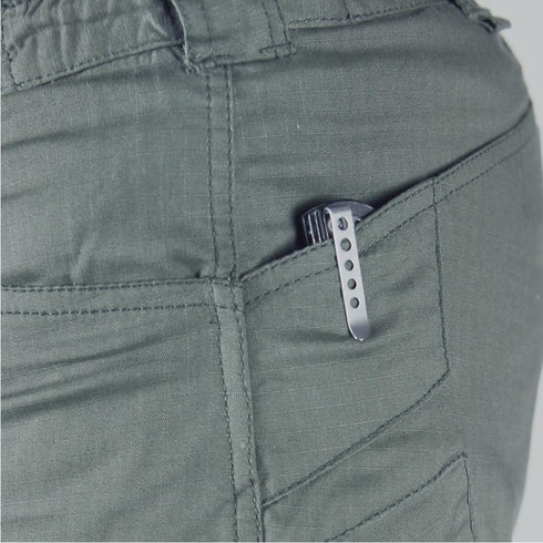A metal pocket clip of a folding knife, part of an EDC setup, is visible clipped to the side pocket of Condor Stealth Operator Pants.