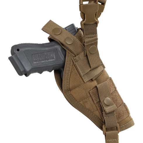 The Condor Vertical Shoulder Holster secures a black handgun in a brown tactical holster with straps and snap buttons, designed for attachment to gear or clothing.