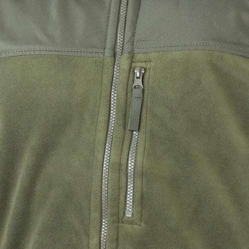 Close-up of the Condor Alpha Fleece Jacket in green, highlighting the visible vertical chest zipper pocket and a portion of the main front zipper.