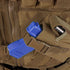 Close-up of the Condor Cross Draw Vest in brown, designed for law enforcement or range use, featuring a blue training pistol in its holster and a metal pen stored in an adjacent pouch.