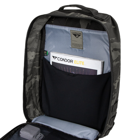Open Condor Prime Pack 21L in MultiCam Black revealing an interior pocket with a Condor Elite booklet and a mesh zippered compartment.