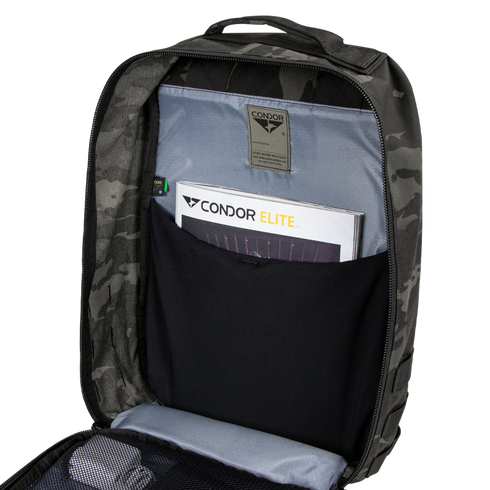 Open Condor Prime Pack 21L in MultiCam Black revealing an interior pocket with a Condor Elite booklet and a mesh zippered compartment.