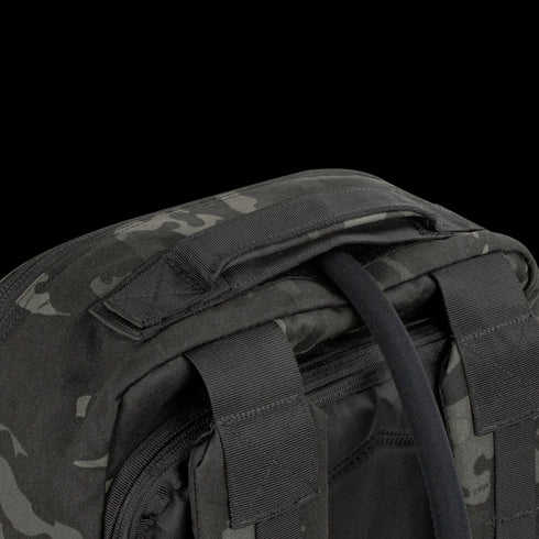 Close-up of the top section of the Condor Prime Pack 21L in MultiCam Black, highlighting its padded carry handle and two adjustable shoulder straps.