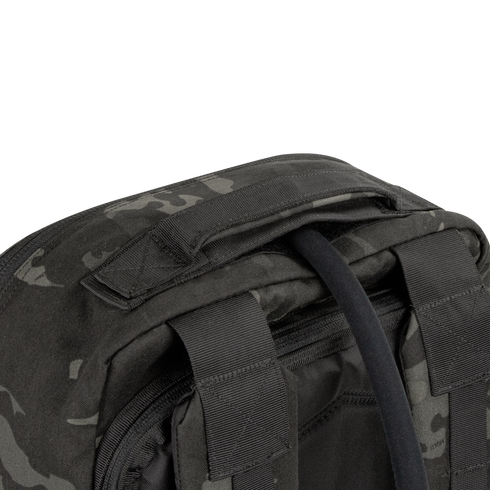 Close-up of the top section of the Condor Prime Pack 21L in MultiCam Black, highlighting its padded carry handle and two adjustable shoulder straps.