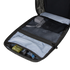 The Condor Prime Pack 21L - MultiCam Black is open on a white surface, revealing mesh pockets with a power adapter, cables, and small tools; wooden blocks are visible in the background.