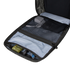 The Condor Prime Pack 21L - MultiCam Black is open on a white surface, revealing mesh pockets with a power adapter, cables, and small tools; wooden blocks are visible in the background.