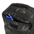 A close-up of the Condor Prime Pack 21L in MultiCam Black with its front zipper pocket open, revealing two blue pens and one black pen inside.