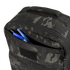 A close-up of the Condor Prime Pack 21L in MultiCam Black with its front zipper pocket open, revealing two blue pens and one black pen inside.