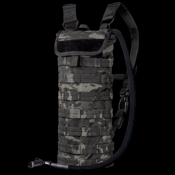 The Condor Hydration Carrier in MultiCam Black features a camouflage pattern, adjustable shoulder straps, and an attached drinking tube for convenient hydration on the go.