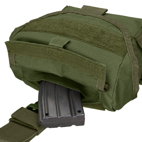 A Condor Drop Leg Dump Pouch in green holds a partially inserted black rifle magazine in its open compartment.