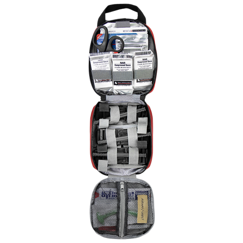 The Condor Rip-Away EMT Pouch opens to reveal scissors, bandages, gauze packs, medical tape, and various supplies neatly organized in mesh and elastic compartments.