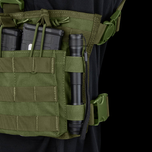 A close-up of the Condor Rapid Assault Chest Rig shows two rifle magazines and a black flashlight secured in green pouches, with visible straps and buckles.