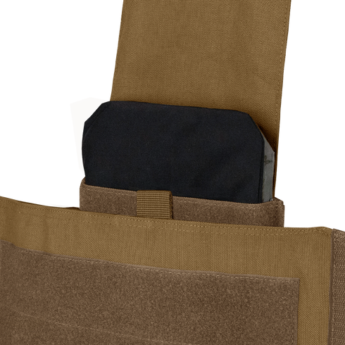 A close-up of a black ballistic plate partially inserted into the pocket of a tan Condor Modular Operator Plate Carrier Gen II.