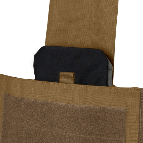 A close-up of a black ballistic plate partially inserted into the front pocket of a Condor Modular Operator Plate Carrier Gen II with a tan Velcro flap.