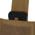 A close-up of a black ballistic plate partially inserted into the front pocket of a Condor Modular Operator Plate Carrier Gen II with a tan Velcro flap.