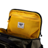 The Condor Nomad Backpack 25L in olive green has a yellow mesh zippered pocket inside the lid with a Condor label—ideal for EDC or first responders.
