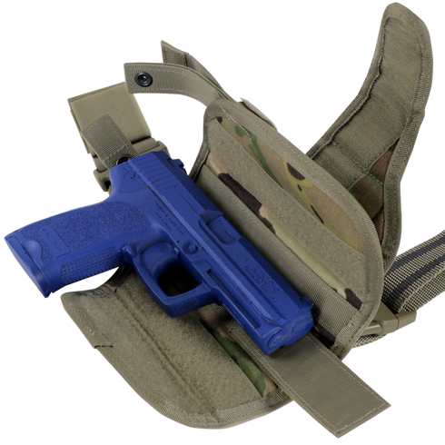 A blue training pistol is placed inside an open Condor Tornado Tactical Leg Holster - Scorpion OCP, featuring khaki camouflage and adjustable straps.