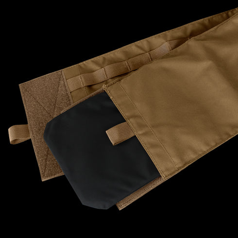 The Cyclone Plate Carrier by Condor features a tan fabric pouch with a pull tab, hook-and-loop flap closure, and a black rectangular object partially inserted.