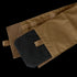 The Cyclone Plate Carrier by Condor features a tan fabric pouch with a pull tab, hook-and-loop flap closure, and a black rectangular object partially inserted.